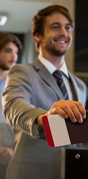 businessman standing with boarding pass check counter